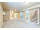 The finished basement is carpeted with a neutral color and has stairs to the 1st floor at 119 Lake Ave, Palmer Lake, CO 80133