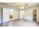 Spacious bedroom features hardwood floors, ceiling fan, and access to bathroom at 119 Lake Ave, Palmer Lake, CO 80133