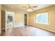 A well-lit bedroom offers hardwood floors, ceiling fan, and neutral color palette at 119 Lake Ave, Palmer Lake, CO 80133