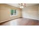 Bedroom with hardwood floors and natural light from a large window at 119 Lake Ave, Palmer Lake, CO 80133