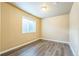 Bedroom with gray floors and a window at 119 Lake Ave, Palmer Lake, CO 80133