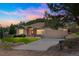 Charming ranch home with a two-car garage and a well-manicured front yard in a serene setting at 119 Lake Ave, Palmer Lake, CO 80133