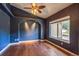 A cozy living room boasts a unique archway and hardwood floors at 119 Lake Ave, Palmer Lake, CO 80133
