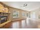 Open living room with hardwood flooring, brick fireplace, large windows and natural light at 119 Lake Ave, Palmer Lake, CO 80133