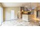 Open floor plan with tiled floors and a partial view of the kitchen with natural wood cabinets at 119 Lake Ave, Palmer Lake, CO 80133