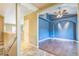 Open space featuring wood floors, blue walls and stairway to the second floor at 119 Lake Ave, Palmer Lake, CO 80133