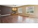 Living room featuring hardwood floors, a cozy fireplace and lots of natural light from the windows at 119 Lake Ave, Palmer Lake, CO 80133