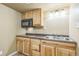 Wet bar features light wood cabinets and a microwave at 119 Lake Ave, Palmer Lake, CO 80133