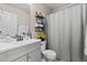 Bathroom featuring a toilet, vanity with sink, and a shower and tub with a shower curtain at 2005 E 103Rd Ave, Thornton, CO 80229