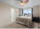 A bedroom with a ceiling fan, bed, and an ensuite bathroom and walk-in closet at 2005 E 103Rd Ave, Thornton, CO 80229