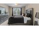 A well-lit bedroom features neutral carpet, a large window, and a mirrored dresser at 2005 E 103Rd Ave, Thornton, CO 80229