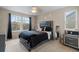Bedroom featuring plush carpet, a large window, and a stylish headboard design at 2005 E 103Rd Ave, Thornton, CO 80229
