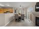 Comfortable dining area with wood-look floors next to an open kitchen at 2005 E 103Rd Ave, Thornton, CO 80229