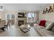 Living room with a fireplace, adjacent dining area, and large windows for plenty of natural light at 2005 E 103Rd Ave, Thornton, CO 80229