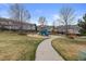 A neighborhood playground with slides, climbing structure, and a grassy area for children to play at 2005 E 103Rd Ave, Thornton, CO 80229