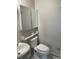 Clean half bath featuring sink, toilet, and mirrored medicine cabinet at 1731 Quail St, Lakewood, CO 80215