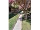 Inviting walkway lined with blossoming trees leading to the charming building entrance at 1731 Quail St, Lakewood, CO 80215