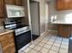 Kitchen with stainless steel appliances and ample wood cabinetry at 1731 Quail St, Lakewood, CO 80215