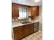 Kitchen with wood cabinets, stainless steel appliances, and tile floor at 1731 Quail St, Lakewood, CO 80215