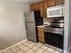 Kitchen area with stainless steel appliances and wood cabinets at 1731 Quail St, Lakewood, CO 80215