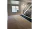 Bright living room with large window and stairs to upper level at 1731 Quail St, Lakewood, CO 80215
