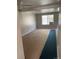 Bright living room with large window featuring neutral paint and carpet flooring at 1731 Quail St, Lakewood, CO 80215