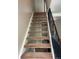 Carpeted stairs leading to the next level with metal railing at 1731 Quail St, Lakewood, CO 80215