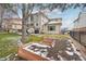 A spacious backyard features a patio, a lawn, and raised garden beds, perfect for outdoor entertaining and gardening at 6281 Mcintyre Way, Golden, CO 80403
