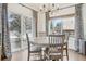 Dining area featuring a round table, chandelier, and sliding glass doors to the backyard at 6281 Mcintyre Way, Golden, CO 80403