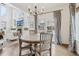 Cozy dining area with a round table, chandelier, and sliding glass doors to the backyard at 6281 Mcintyre Way, Golden, CO 80403