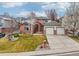 This home's exterior features a brick facade, a large yard, and a convenient two-car garage at 6281 Mcintyre Way, Golden, CO 80403