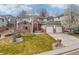This gorgeous home features a brick facade, lush front lawn, and a 2-car garage with a wide driveway at 6281 Mcintyre Way, Golden, CO 80403