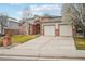 Charming two-story brick home with a well-maintained lawn and two-car garage at 6281 Mcintyre Way, Golden, CO 80403