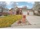 Charming two-story brick home with a well-maintained lawn and two-car garage at 6281 Mcintyre Way, Golden, CO 80403