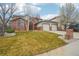 Charming two-story brick home with a well-maintained lawn and two-car garage at 6281 Mcintyre Way, Golden, CO 80403