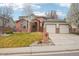 Charming two-story brick home with a well-maintained lawn and two-car garage at 6281 Mcintyre Way, Golden, CO 80403