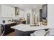 Well-appointed kitchen with white and dark cabinets, quartz countertops, and a gold faucet at 6281 Mcintyre Way, Golden, CO 80403