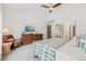Bedroom showcasing a dresser, lounge chair, and leaf-patterned bedding with a fan at 6281 Mcintyre Way, Golden, CO 80403