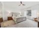 A bedroom with a gray bed frame, leaf print bedding, two bedside tables, and a fan at 6281 Mcintyre Way, Golden, CO 80403