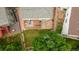 Aerial view of a backyard featuring a deck, patio, lawn and mature trees in a fenced yard at 5075 Weeping Willow Cir, Highlands Ranch, CO 80130