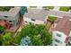 Aerial view of a home showing the backyard with a deck, patio, mature trees, and surrounding fenced yard at 5075 Weeping Willow Cir, Highlands Ranch, CO 80130