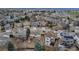 An aerial view showcasing the backyard of the house with a deck and mature trees in a residential neighborhood at 5075 Weeping Willow Cir, Highlands Ranch, CO 80130