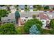 An aerial view of a well-maintained backyard with a deck and mature trees in a residential neighborhood at 5075 Weeping Willow Cir, Highlands Ranch, CO 80130