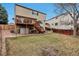 Spacious backyard featuring a wooden deck and lush greenery for outdoor enjoyment at 5075 Weeping Willow Cir, Highlands Ranch, CO 80130
