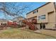 A cozy backyard view with a wood deck, lush lawn, and access through sliding glass doors at 5075 Weeping Willow Cir, Highlands Ranch, CO 80130