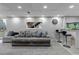 Finished basement area with comfortable seating, bar area, neutral carpet and paint, and recessed lighting at 5075 Weeping Willow Cir, Highlands Ranch, CO 80130