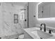 Modern bathroom featuring marble tiling, a sleek sink, and a glass-enclosed shower at 5075 Weeping Willow Cir, Highlands Ranch, CO 80130