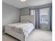 Bedroom featuring a white bed frame, two windows with blue curtains and grey paint at 5075 Weeping Willow Cir, Highlands Ranch, CO 80130