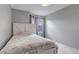Bedroom featuring a white bed frame, two windows with blue curtains and grey paint at 5075 Weeping Willow Cir, Highlands Ranch, CO 80130
