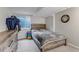 Bedroom features a wood bed frame, grey comforter, dresser, and a small window at 5075 Weeping Willow Cir, Highlands Ranch, CO 80130